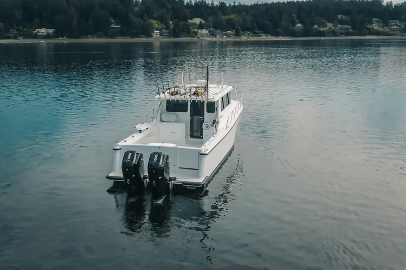 Slide: The Image of A 2027 Lindell 41' boat with dual engines on a serene lake. - 7
