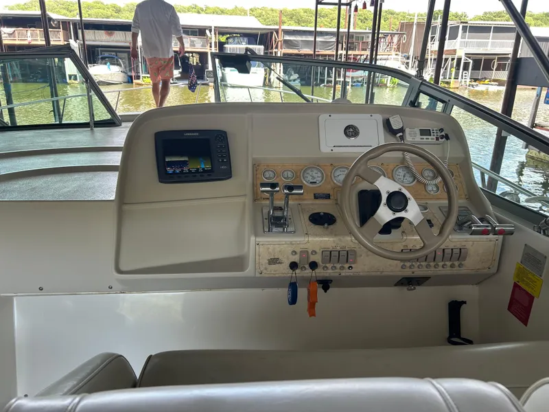 Slide: The Image of 1997 Cruisers Yachts 3575 Esprit helm with steering wheel, controls, and navigation equipment. - 12