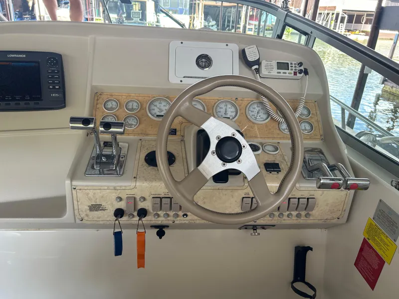 Slide: The Image of 1997 Cruisers Yachts 3575 Esprit helm with steering wheel and control panel. - 13