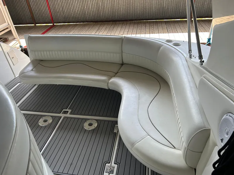 Slide: The Image of 1997 Cruisers Yachts 3575 Esprit interior with curved white seating and gray flooring. - 14