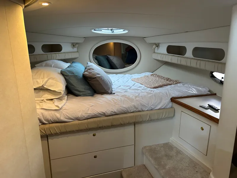 Slide: The Image of 1997 Cruisers Yachts 3575 Esprit cabin interior with bed, pillows, and storage. - 20