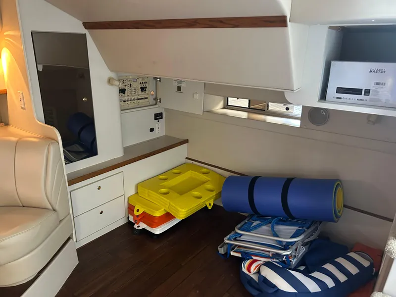 Slide: The Image of 1997 Cruisers Yachts 3575 Esprit interior with storage, seating, and nautical equipment. - 21