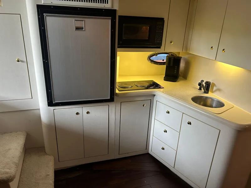 Slide: The Image of 1997 Cruisers Yachts 3575 Esprit kitchen with fridge, microwave, stove, and sink. - 22