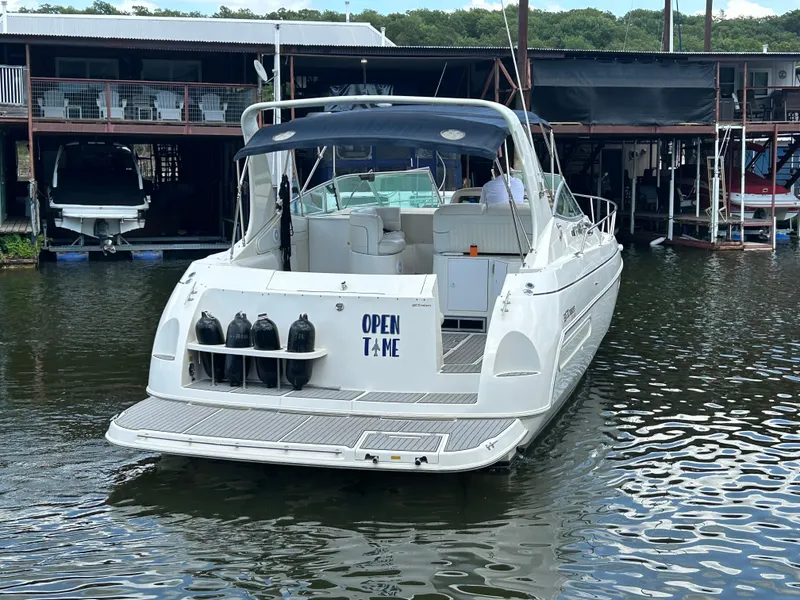 Slide: The Image of 1997 Cruisers Yachts 3575 Esprit docked at marina, rear view with canopy. - 3