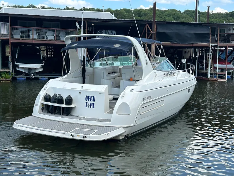 Slide: The Image of 1997 Cruisers Yachts 3575 Esprit docked, featuring sleek design and spacious deck. - 4