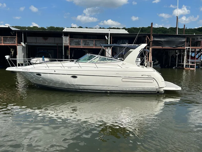 Slide: The Image of 1997 Cruisers Yachts 3575 Esprit docked on calm water under a clear sky. - 8