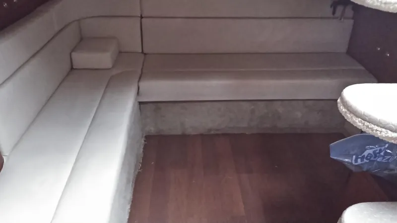 Slide: The Image of Interior seating area of a 2004 Sea Ray 340 Sundancer boat with beige upholstery. - 13