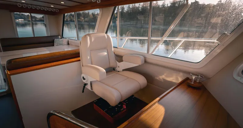 Slide: The Image of Luxurious interior of 2025 Lindell 42' yacht with captain's chair and scenic window view. - 11