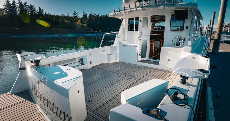 Slide: The Image of 2025 Lindell 42' yacht with spacious deck and modern interior at a serene marina. - 8