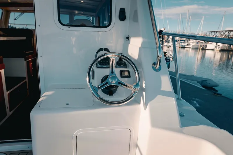Slide: The Image of Steering wheel of a 2027 Lindell 42' boat docked at a marina. - 16