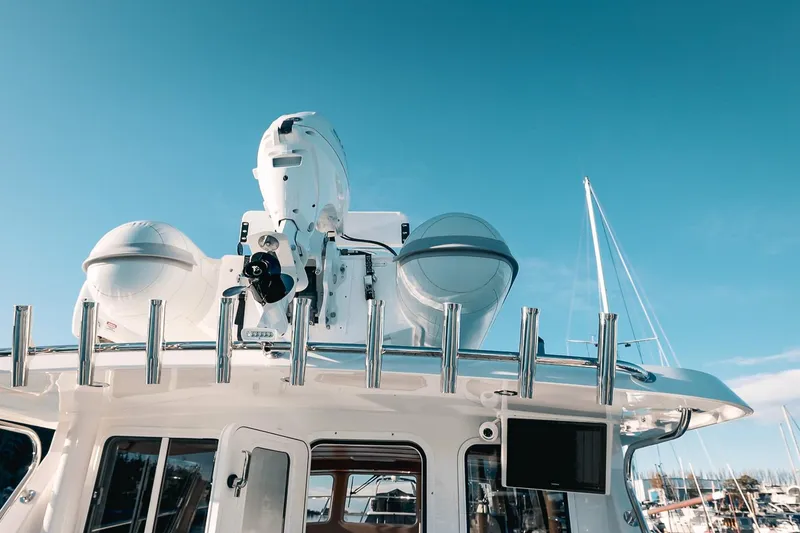 Slide: The Image of Modern Lindell 42' yacht, 2027 model, featuring advanced radar equipment against a clear blue sky. - 17