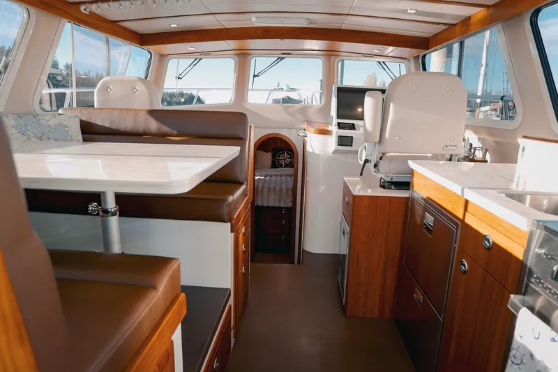 Slide: The Image of Luxurious interior of a 2027 Lindell 42' yacht featuring modern seating and elegant wood finishes. - 18