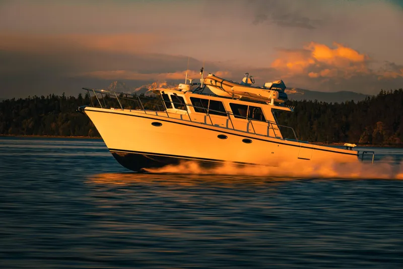Slide: The Image of 2025 Lindell 42' yacht cruising on serene waters at sunset. - 2
