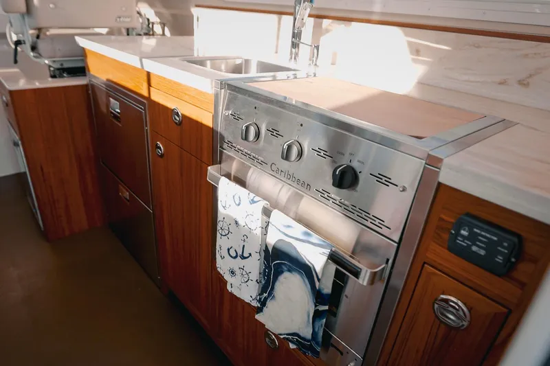Slide: The Image of Modern kitchen in 2027 Lindell 42' yacht with stainless steel appliances and wooden cabinetry. - 20