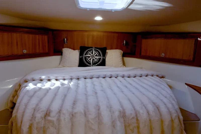 Slide: The Image of Luxurious cabin interior of 2027 Lindell 42' yacht with plush bedding and wooden accents. - 25