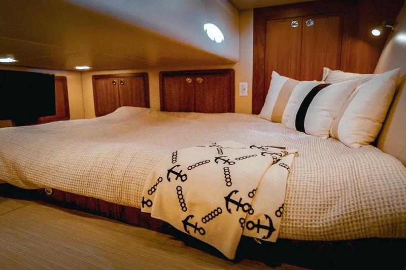 Slide: The Image of Luxurious cabin interior of 2027 Lindell 42' yacht with cozy bedding and anchor-themed blanket. - 27
