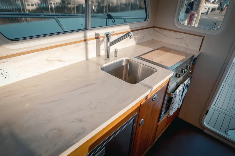 Slide: The Image of Modern kitchen in 2027 Lindell 42' yacht with marble countertop and stainless steel sink. - 31