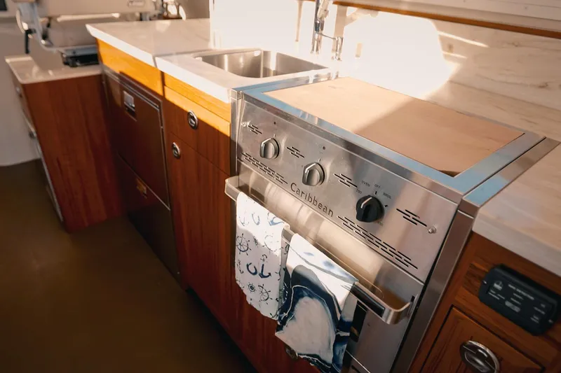 Slide: The Image of Modern kitchen in 2027 Lindell 42' yacht with stainless steel appliances and wooden cabinetry. - 33