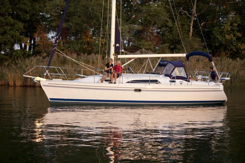 Slide: The Image of 2024 Catalina 355 sailboat on calm water with people onboard. - 13