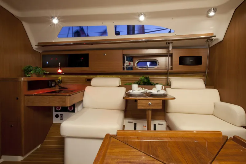 Slide: The Image of Luxurious interior of 2024 Catalina 355 sailboat with cozy seating and wooden finishes. - 6