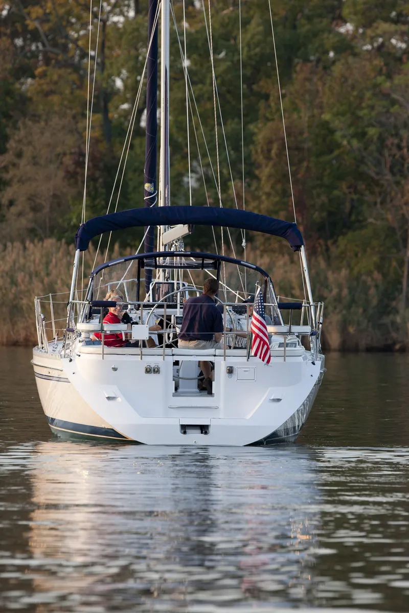 Slide: The Image of 2024 Catalina 355 sailboat cruising on a calm lake with passengers. - 14