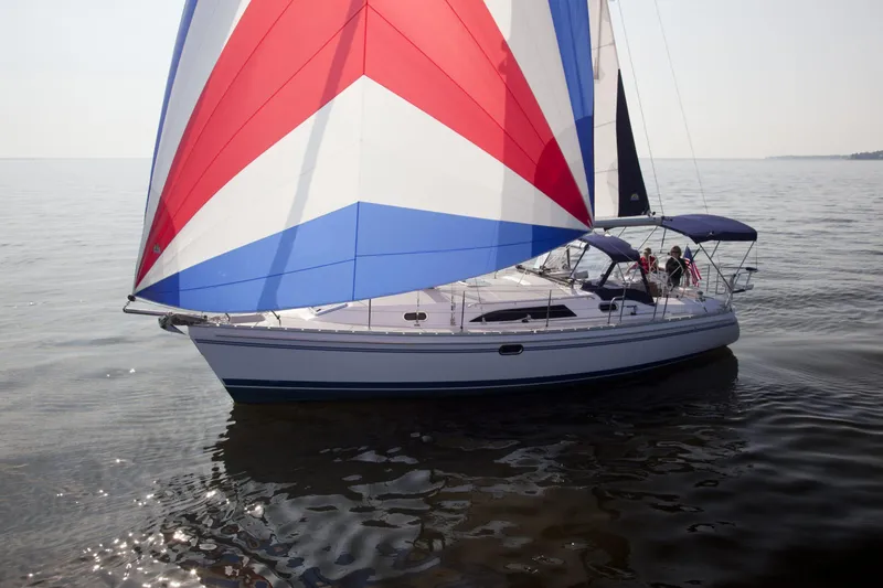Slide: The Image of 2024 Catalina 355 sailboat with colorful spinnaker on calm water. - 16