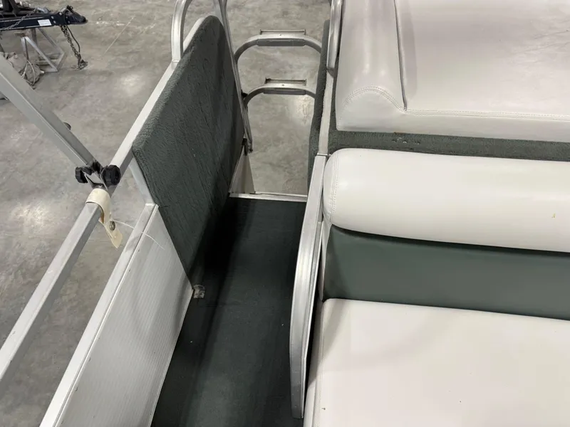 Slide: The Image of Interior of 2001 PlayCraft 2600 Powertoon boat with white and green seating. - 10