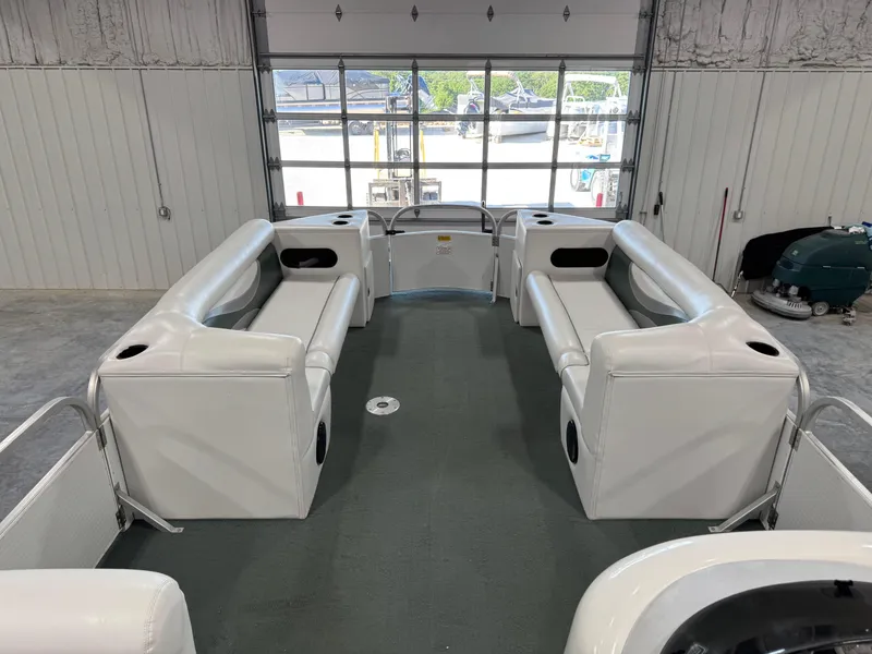 Slide: The Image of 2001 PlayCraft 2600 Powertoon interior with white seating in a garage setting. - 11