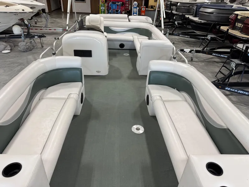 Slide: The Image of 2001 PlayCraft 2600 Powertoon pontoon boat interior with white seating in showroom. - 12
