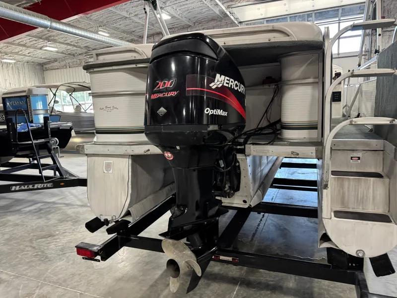 Slide: The Image of 2001 PlayCraft 2600 Powertoon with Mercury OptiMax engine in a showroom. - 14