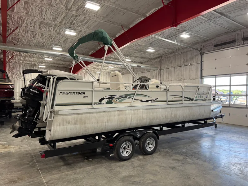 Slide: The Image of 2001 PlayCraft 2600 Powertoon pontoon boat on trailer in indoor storage facility. - 3