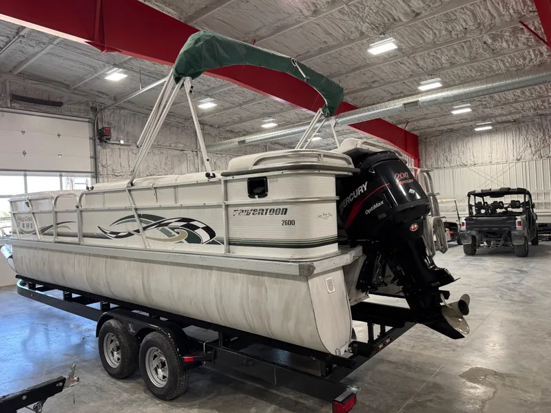 Slide: The Image of 2001 PlayCraft 2600 Powertoon pontoon boat on trailer in indoor storage facility. - 4