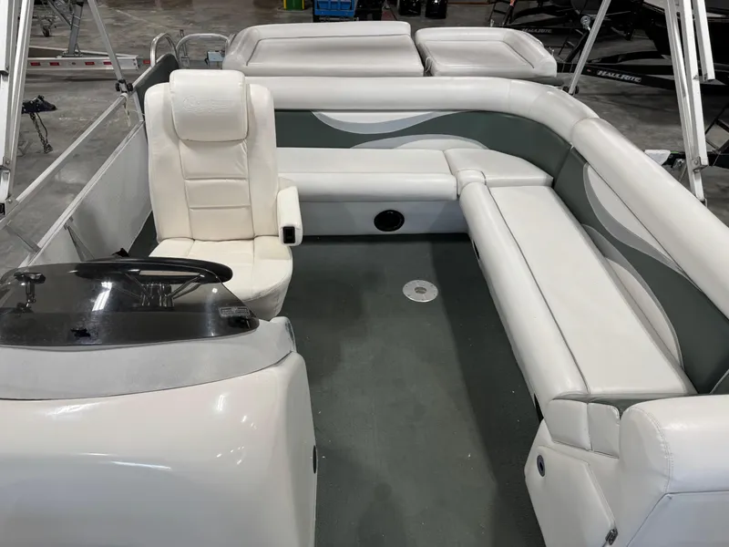 Slide: The Image of 2001 PlayCraft 2600 Powertoon boat interior with white seating and steering console. - 8