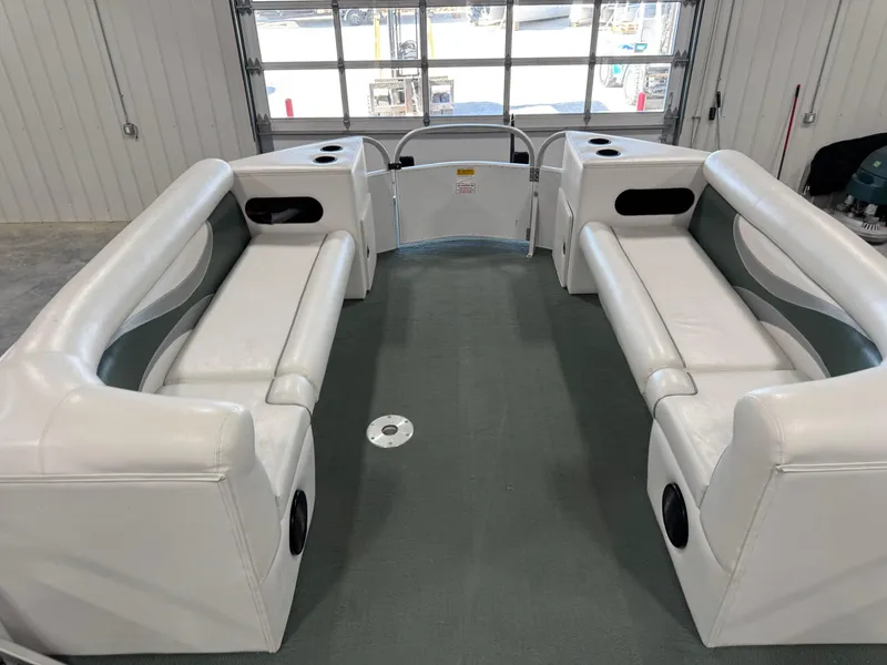 Slide: The Image of Interior of 2001 PlayCraft 2600 Powertoon boat with white seating and cup holders. - 9