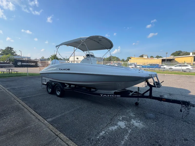 Slide: The Image of 2020 Tahoe 2150 CC boat on trailer under clear blue sky. - 10