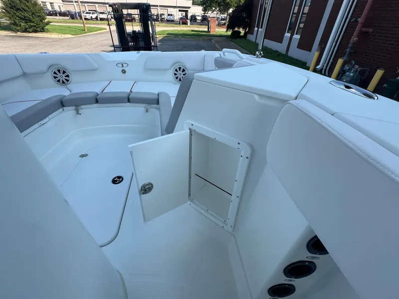 Slide: The Image of 2020 Tahoe 2150 CC boat interior with open storage compartment and seating area. - 14