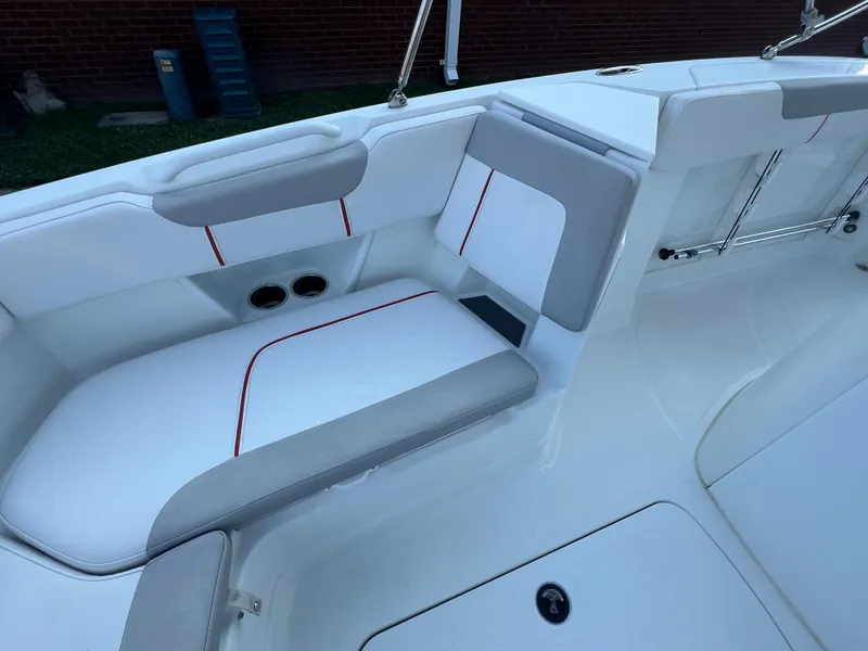 Slide: The Image of 2020 Tahoe 2150 CC boat interior with white and gray seating, red accents. - 16