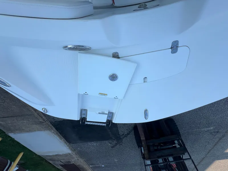 Slide: The Image of 2020 Tahoe 2150 CC boat with a white deck and foldable ladder. - 17