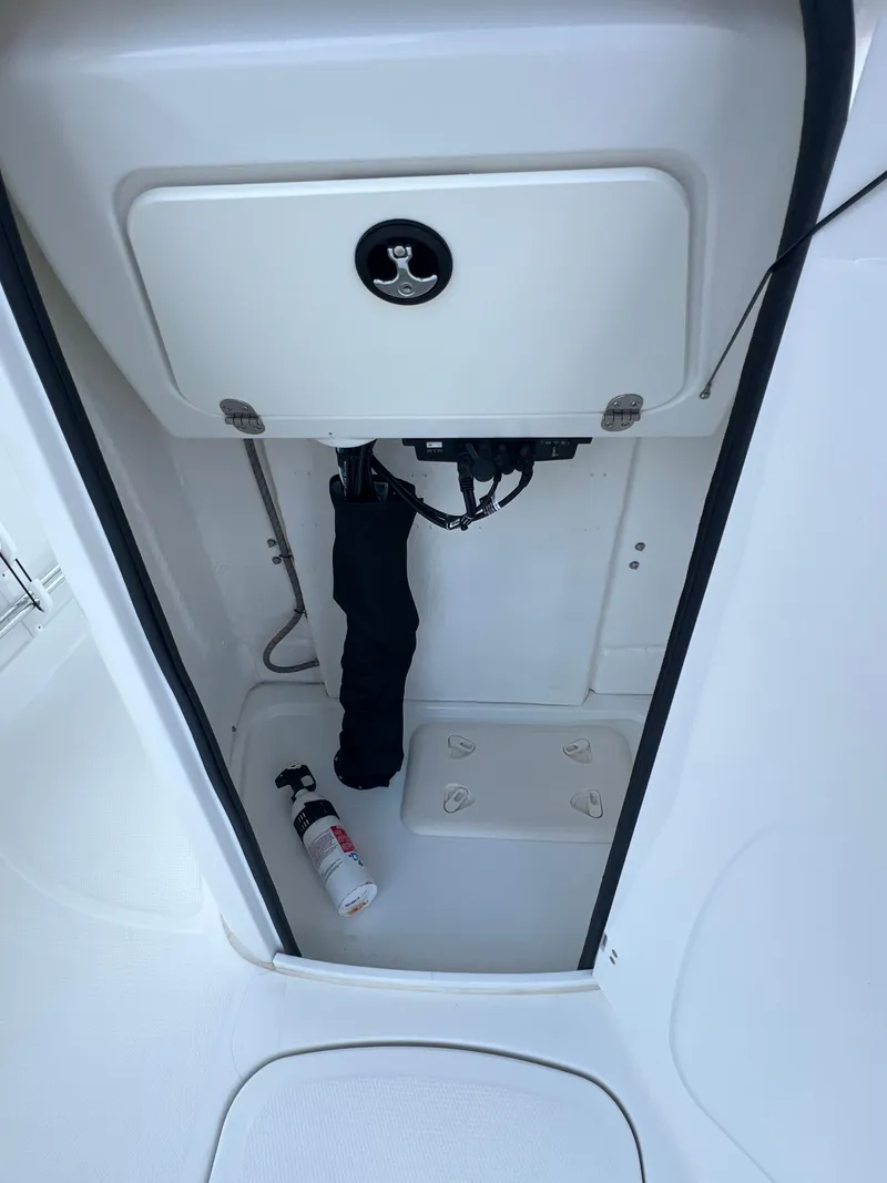 Slide: The Image of Storage compartment in a 2020 Tahoe 2150 CC boat with fire extinguisher. - 18