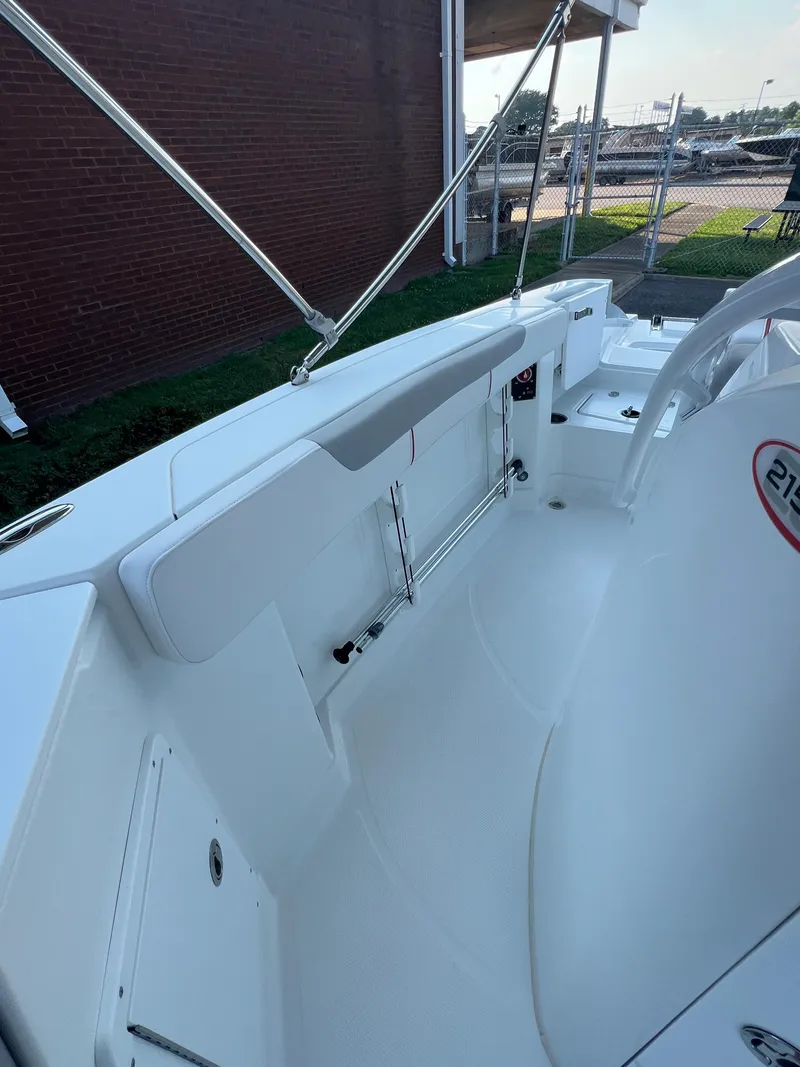 Slide: The Image of 2020 Tahoe 2150 CC boat interior with white seating and stainless steel railings. - 20