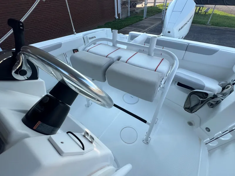 Slide: The Image of 2020 Tahoe 2150 CC boat interior with steering wheel and seating area. - 22