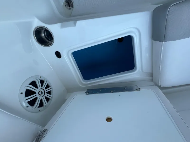 Slide: The Image of Interior of 2020 Tahoe 2150 CC boat showing speaker and storage compartment. - 23