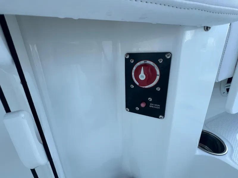 Slide: The Image of 2020 Tahoe 2150 CC boat's main breaker switch panel with red dial. - 24
