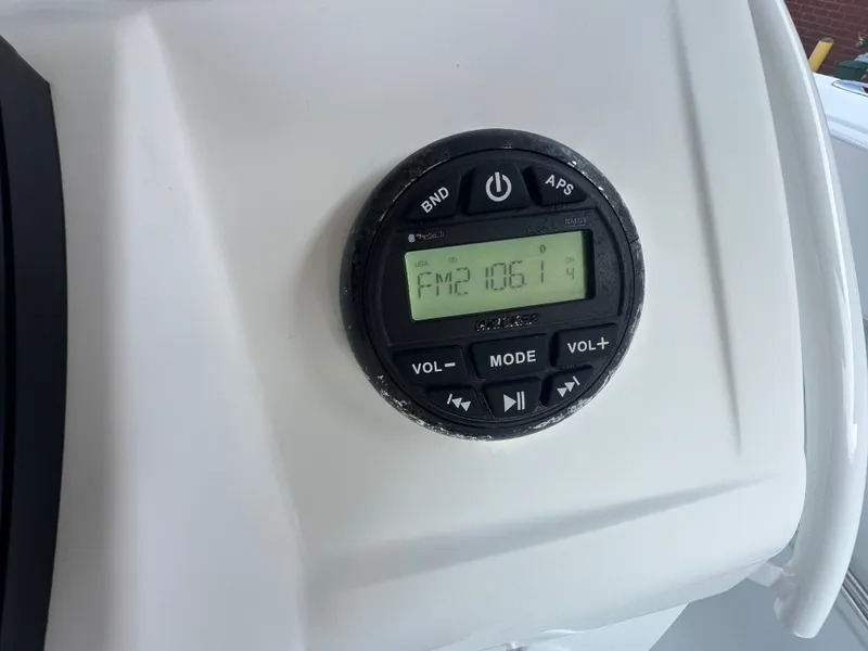 Slide: The Image of Radio control panel on 2020 Tahoe 2150 CC boat, displaying FM 106.1 frequency. - 28