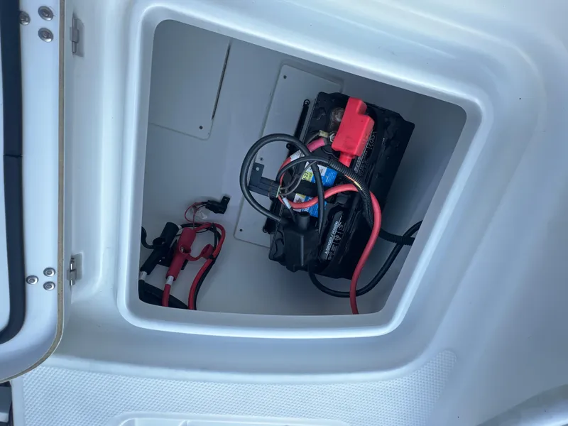 Slide: The Image of Battery compartment of a 2020 Tahoe 2150 CC boat with cables and connections. - 29