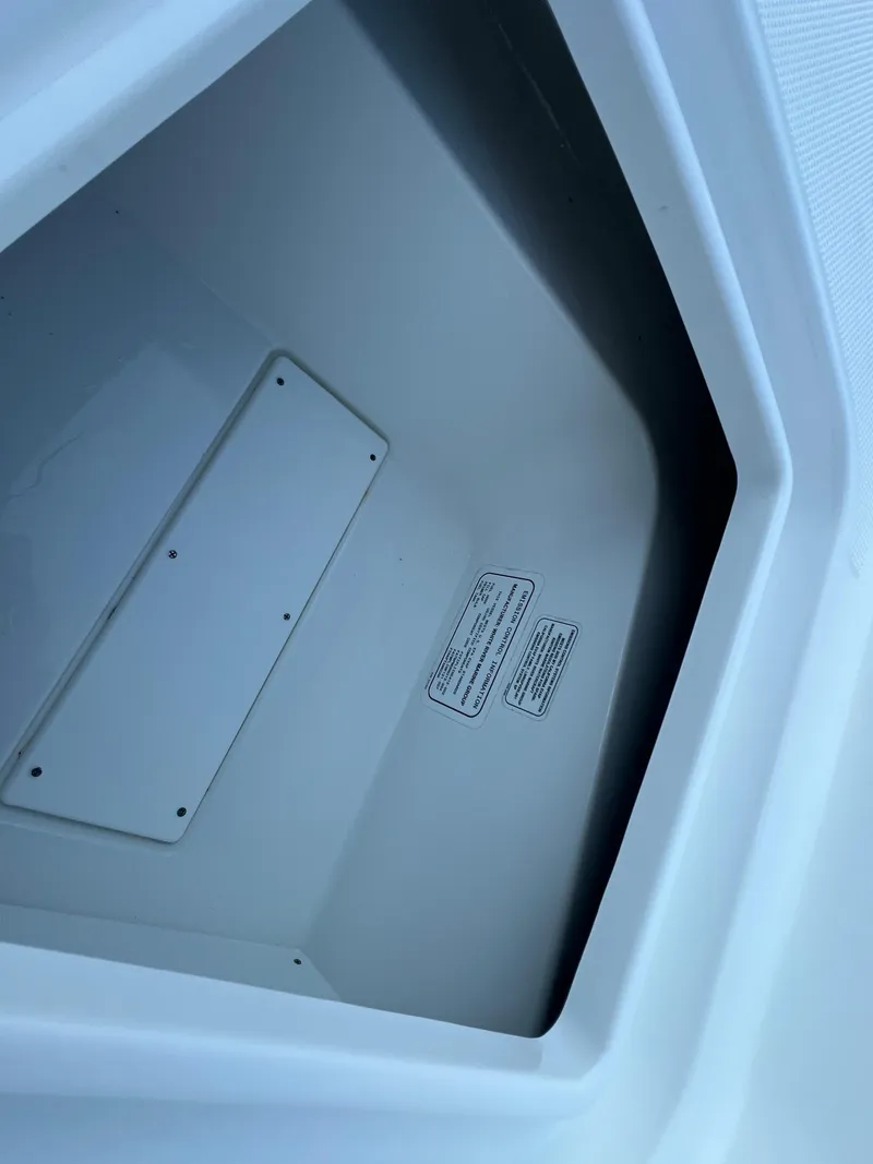 Slide: The Image of Storage compartment of a 2020 Tahoe 2150 CC boat, featuring a clean, white interior. - 31