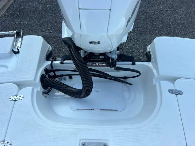 Slide: The Image of 2020 Tahoe 2150 CC boat engine area with SeaStar hydraulic steering system. - 33