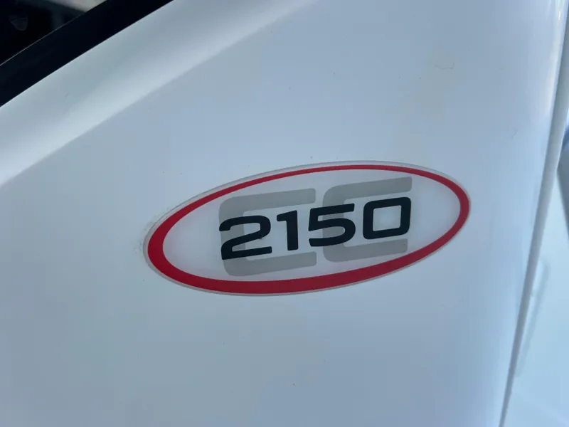 Slide: The Image of 2020 Tahoe 2150 CC logo on white surface, red oval design. - 34