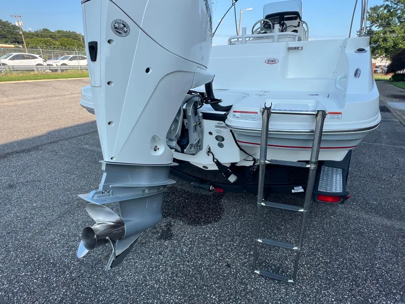 Slide: The Image of 2020 Tahoe 2150 CC boat rear view with outboard motor and ladder. - 36