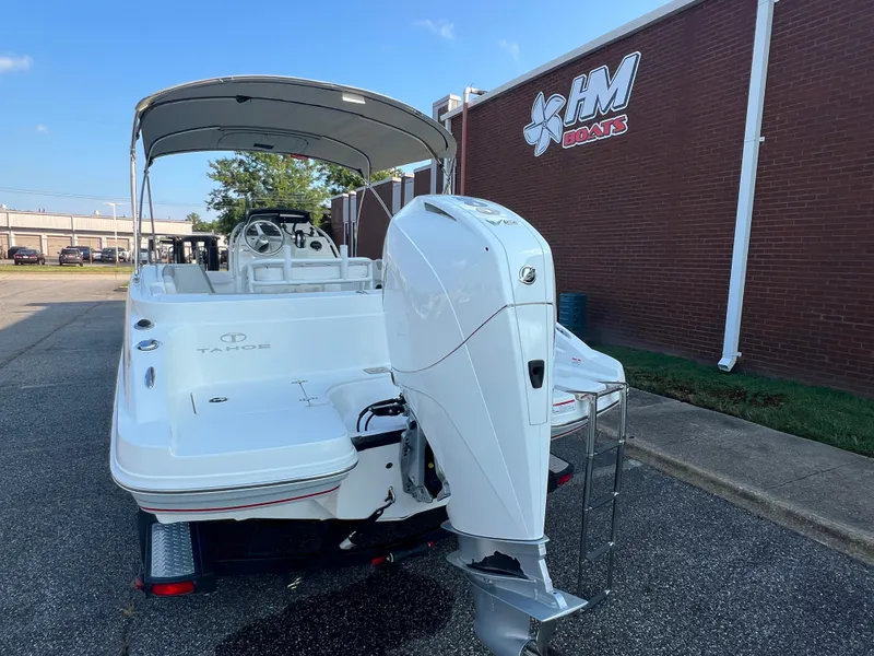 Slide: The Image of 2020 Tahoe 2150 CC boat with outboard motor, parked near HM Boats building. - 37